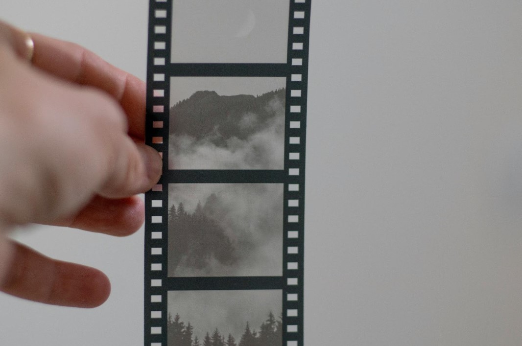 A film roll showing images of landscape mountains with fog.