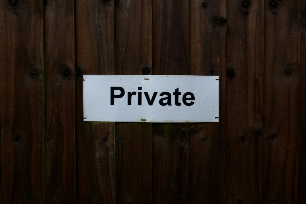 A private sign on a wooden door.