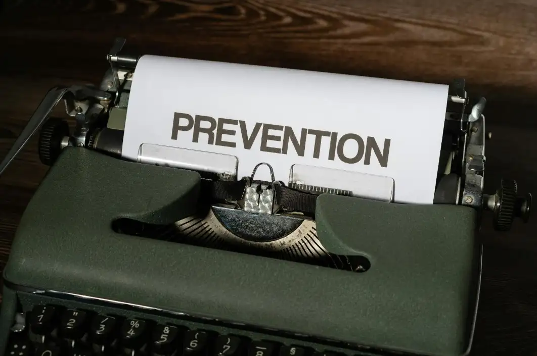 The word "PREVENTION" on a peice of paper coming out of an old school typewriter.