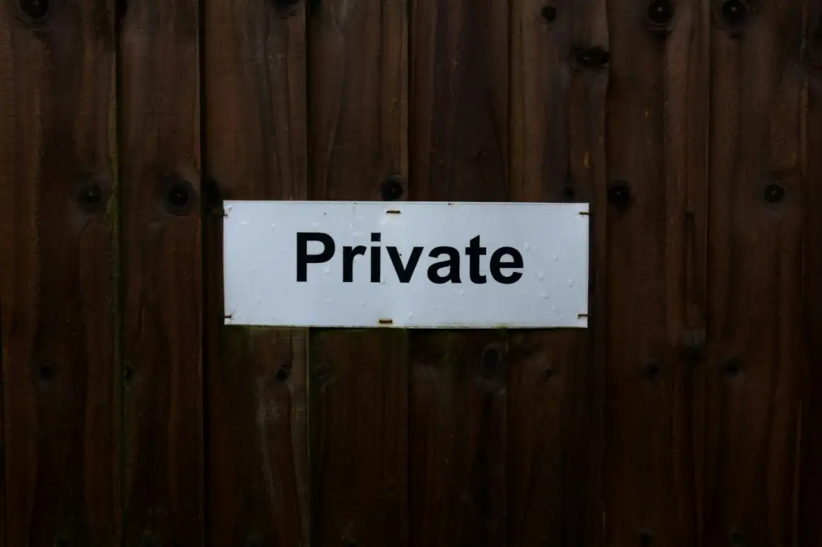 A private sign on a wooden door.
